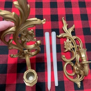 Antique style wall candle holders with candles.